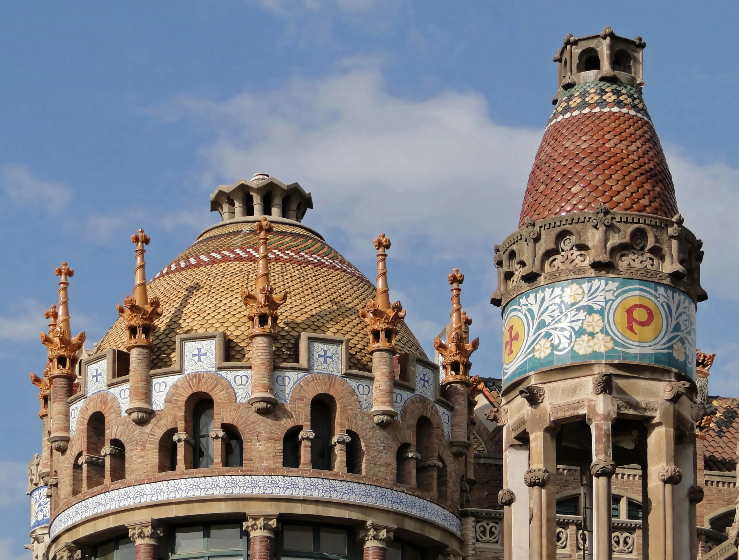 De kleurrijke torens en mozaïekgevels van het Hospital de Sant Pau, gezien vanuit de tuinen